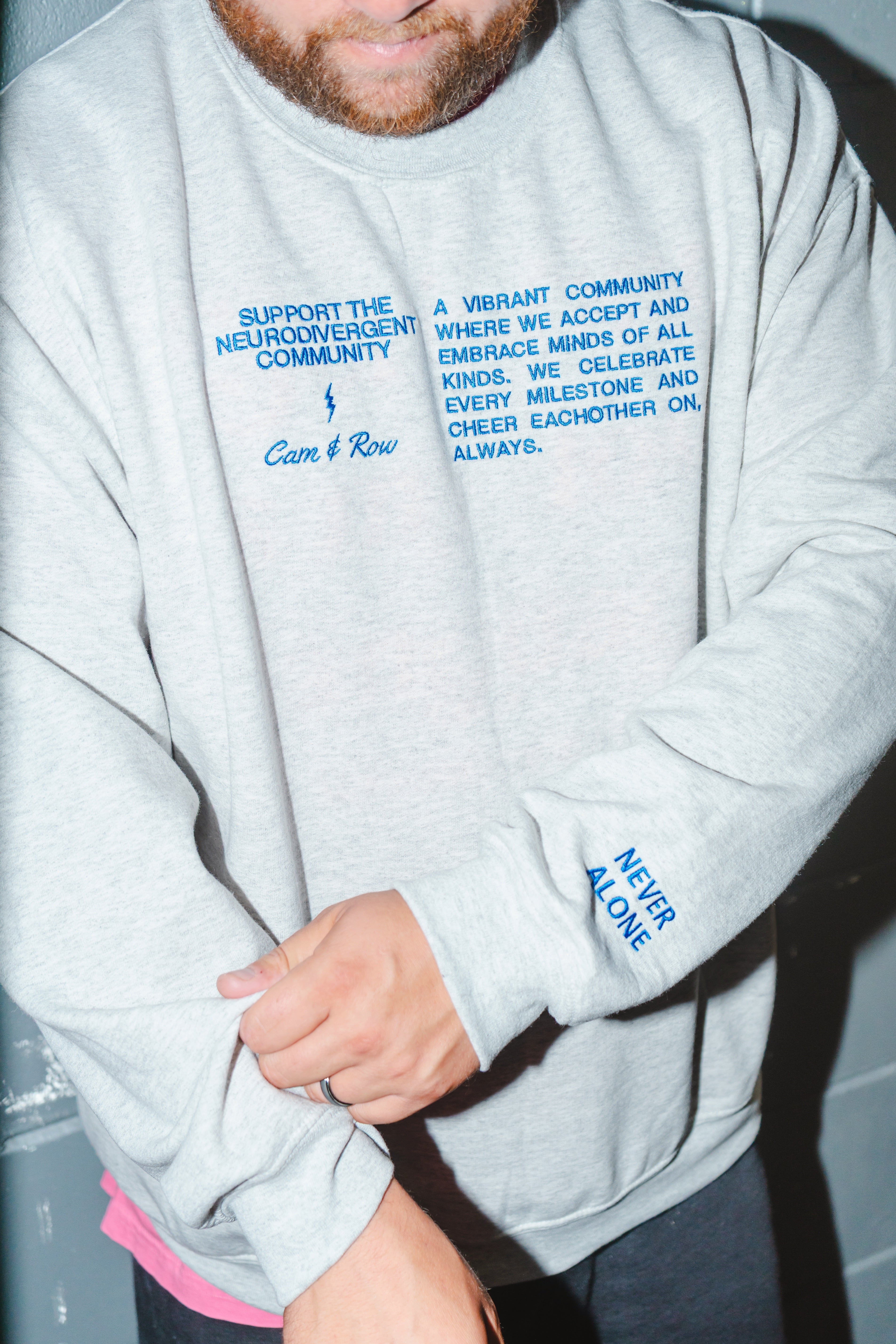 Unisex "Never Alone" Embroidered Sweatshirt